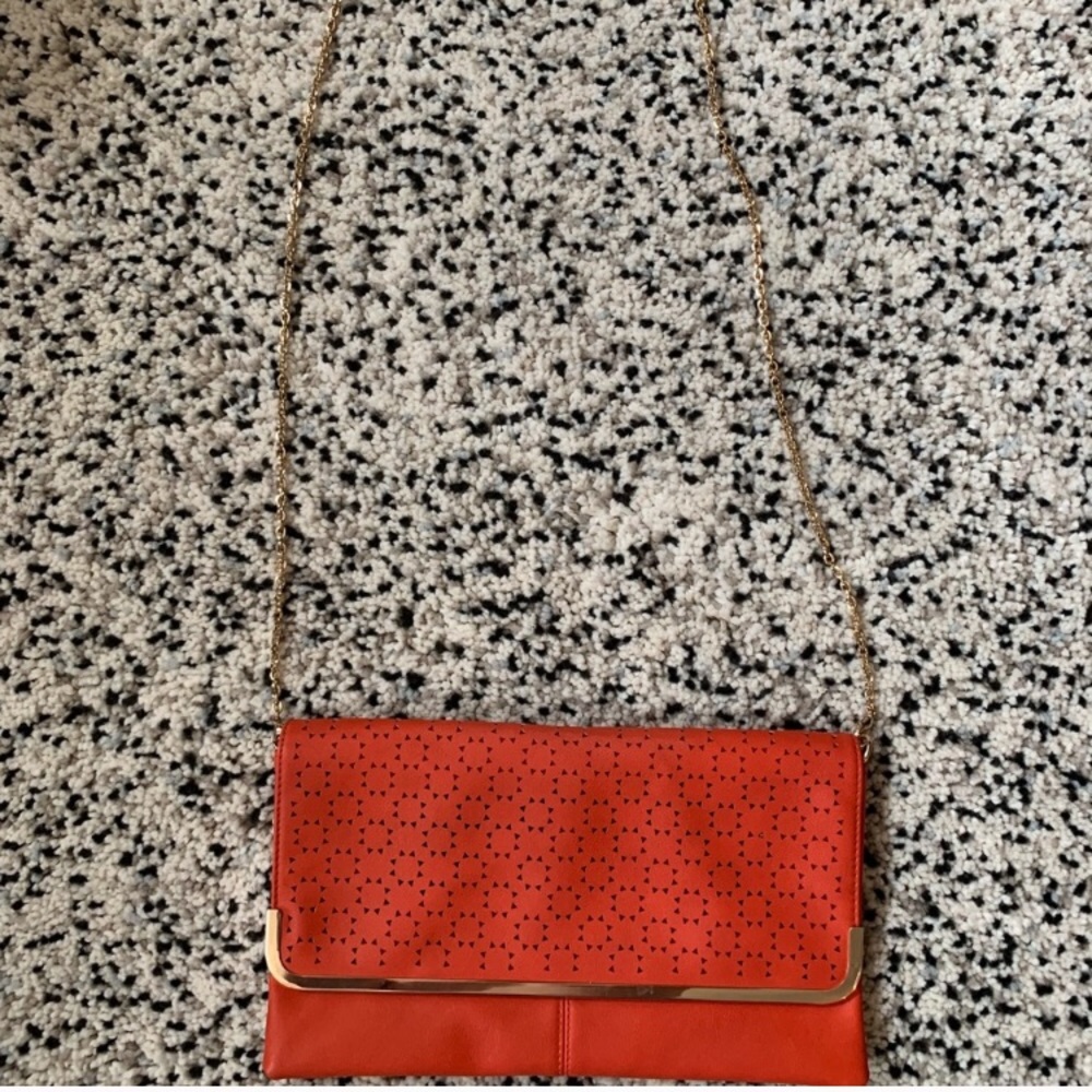Large clutch with detachable gold shoulder strap.